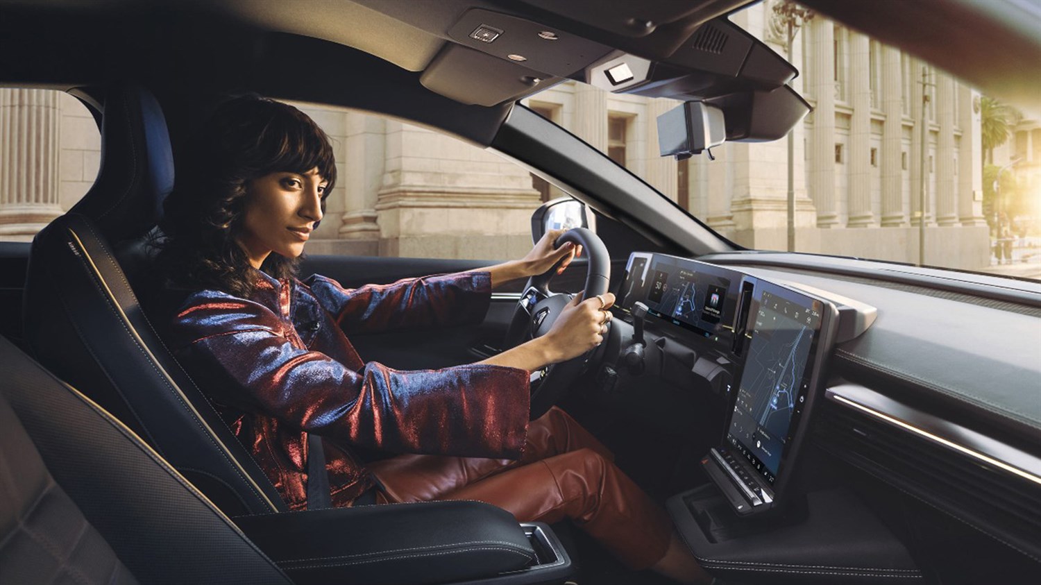 A driver drives along with the Renault onboard multimedia system