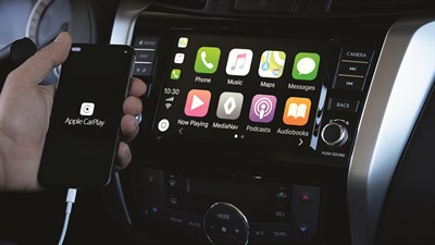 A man connected his iPhone with the Renault Carminat TomTom system and opening the Apple CarPlay app