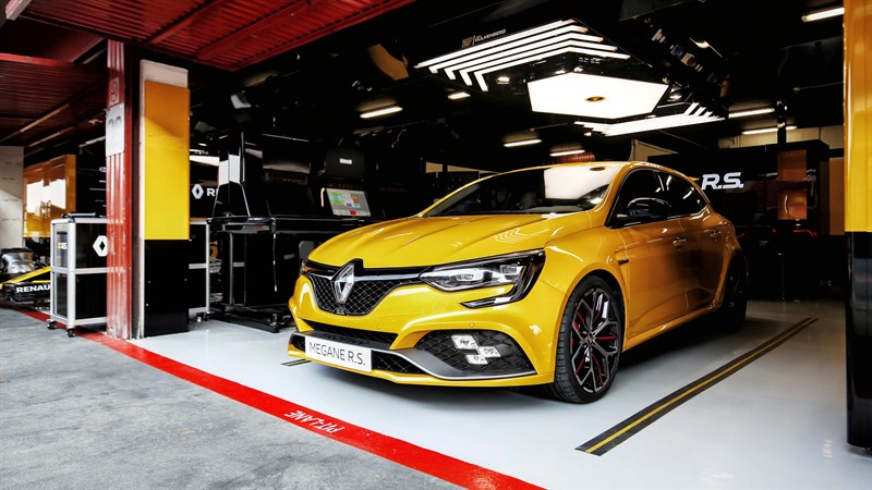 Yellow-colored Renault MEGANE R.S. Trophy parked inside a racing garage