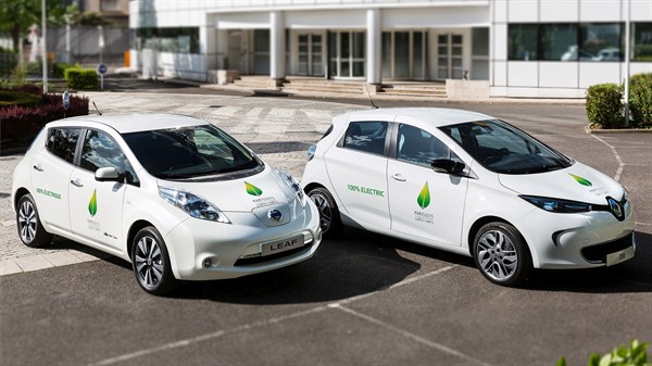 2 different white color Renault cars are standing at a COP21 event