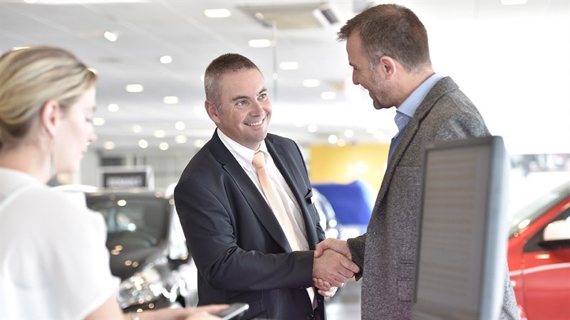 A customer shakes hand with Renault salesman