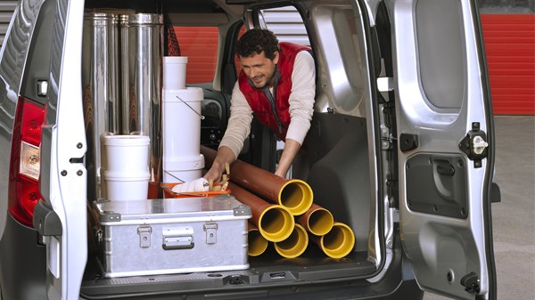 A man uploading goods into a Renault Dokker Van